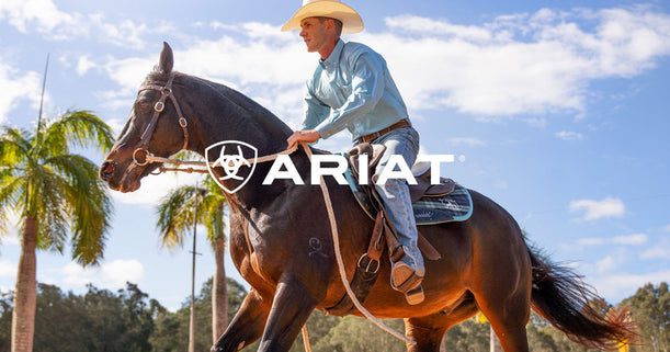 Cowboy riding horse dressed in Ariat Clothing
