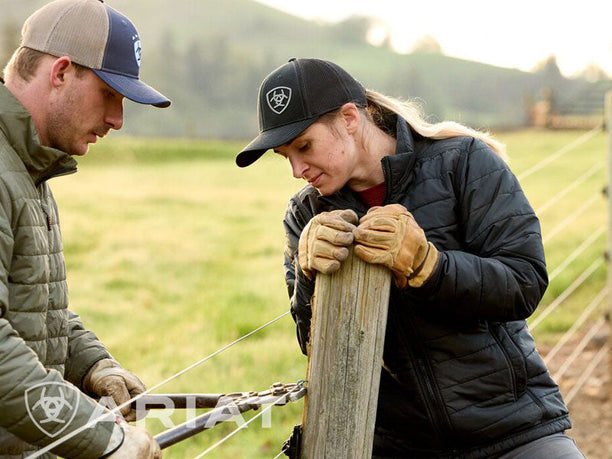 Women working outdoors in arait work gear including jacket, gloves , cap and pants.