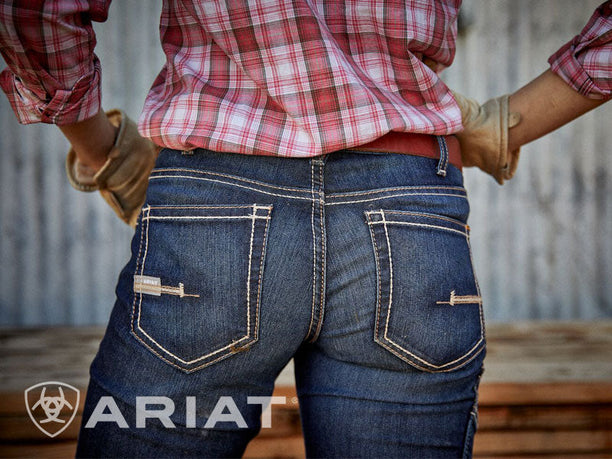 Working woman in shed wearing Ariat denim jeans with pocket details
