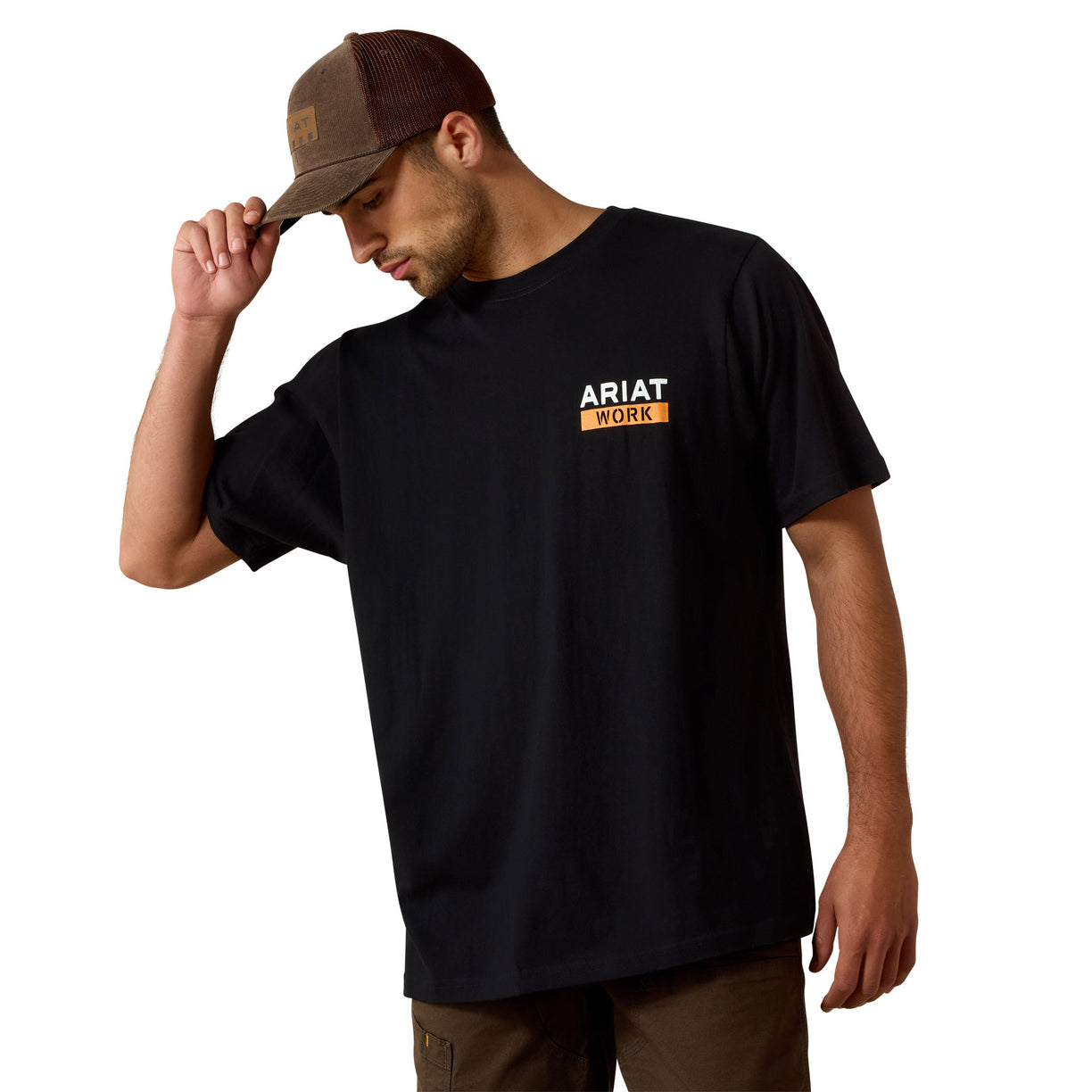 Man wearing a black Ariat t-shirt and brown cap on a white background
