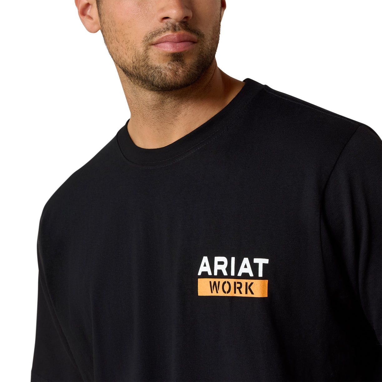 Black Ariat work shirt worn by a person on a white background