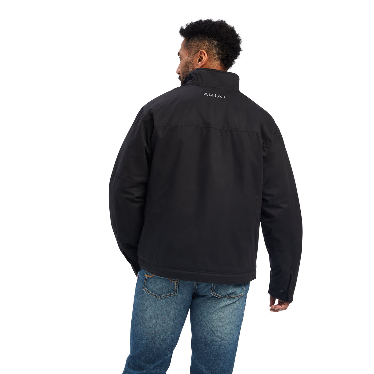 A man wearing a black Grizzly canvas jacket with a sherpa lined collar, multiple zippered pockets, and standing collar.