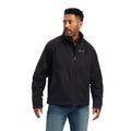 A man wearing a black Grizzly canvas jacket with a sherpa lined collar, multiple zippered pockets, and standing collar.