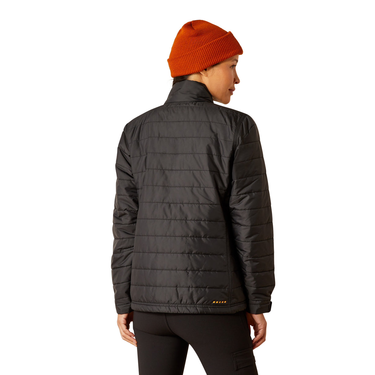 Person wearing a dark gray puffer jacket and orange beanie on a white background