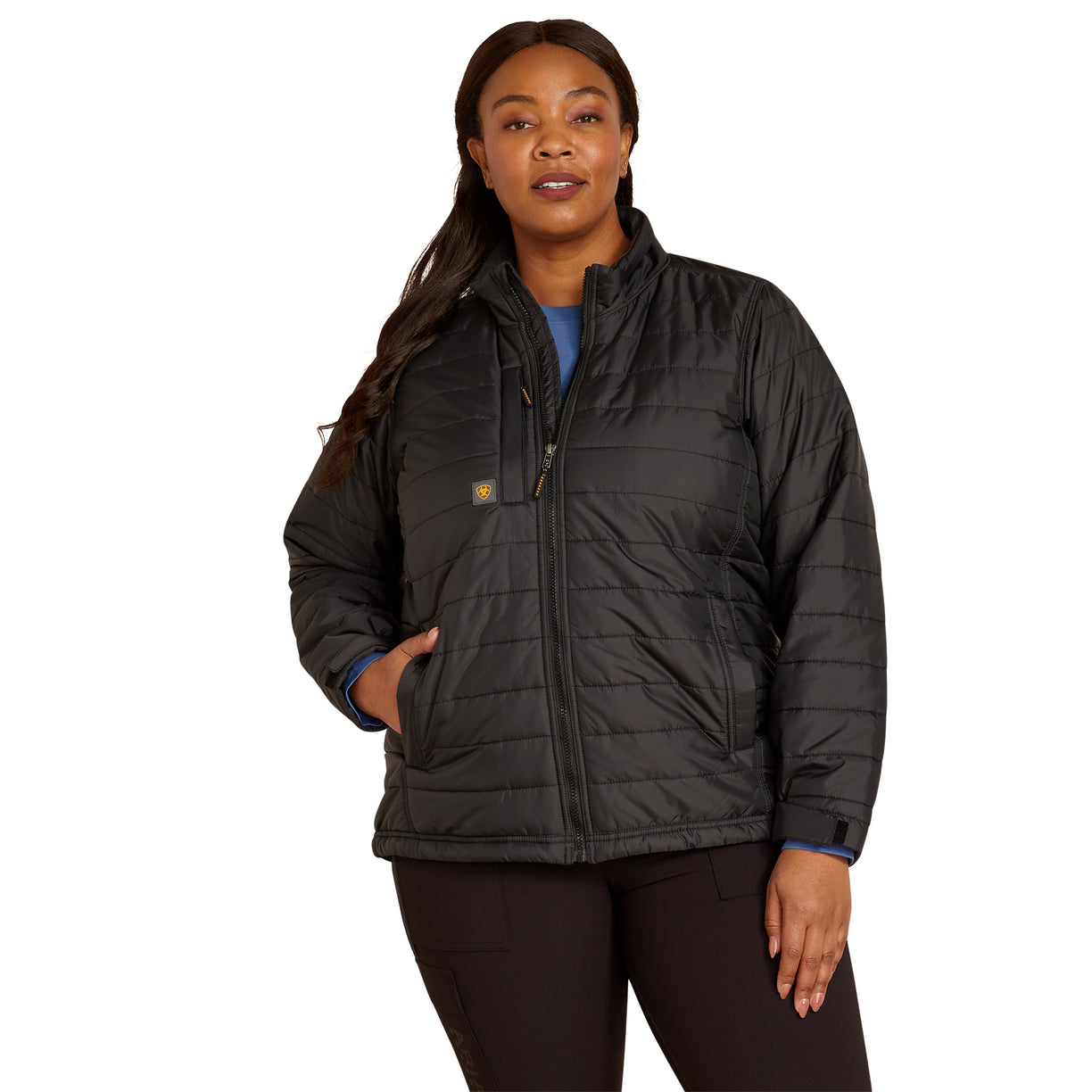 Woman wearing a black quilted jacket on a white background