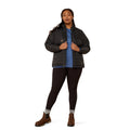 Person wearing a black puffer jacket over a blue shirt on a white background