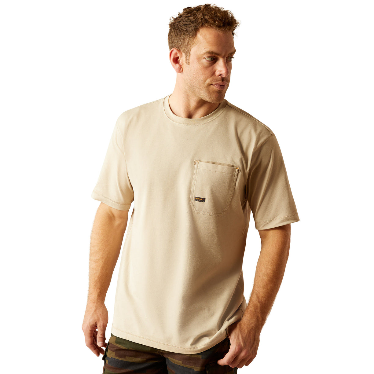 Man wearing a beige t-shirt with 'Ariat Work Est. 1993' print on the back, on a white background