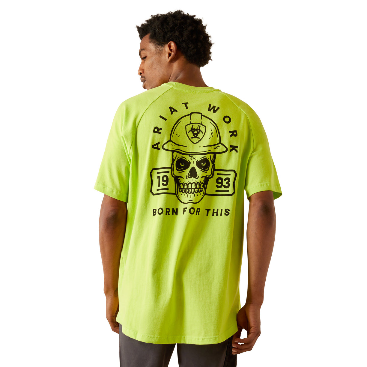 Person wearing a bright yellow t-shirt with a skull and hard hat graphic on the back.
