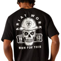 Person wearing a black t-shirt with a skull and hard hat graphic on the back.