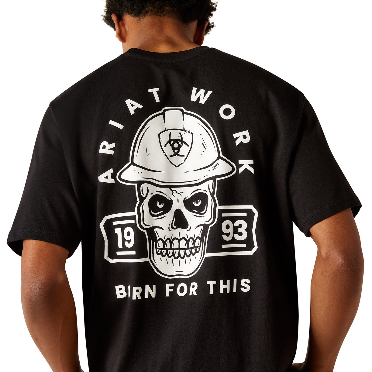 Person wearing a black t-shirt with a skull and hard hat graphic on the back.