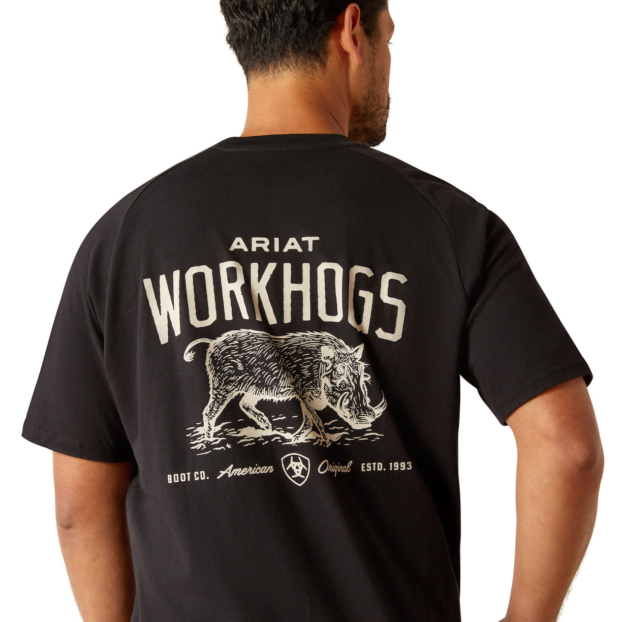 Black t-shirt with 'Ariat Workhogs' graphic on the back, worn by a person.