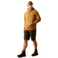 Man wearing a brown hoodie with Ariat Work branding and cap on a white background