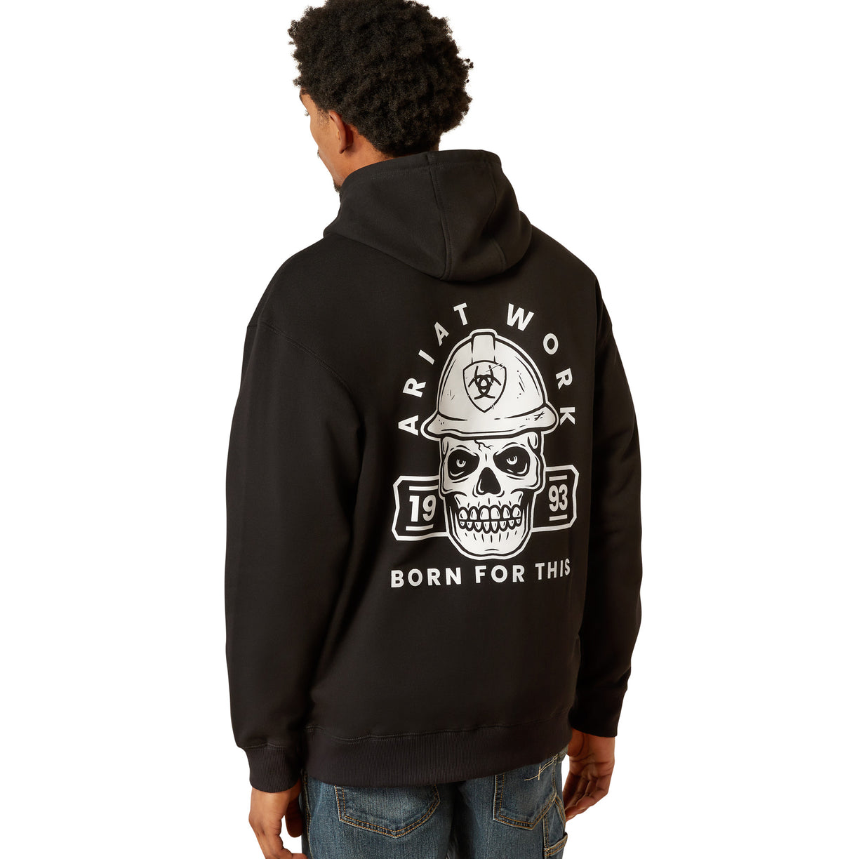 Person wearing a black hoodie with a skull and hard hat design on the back, on a white background.