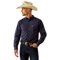 Man wearing a navy patterned shirt, jeans, and a straw cowboy hat on a white background