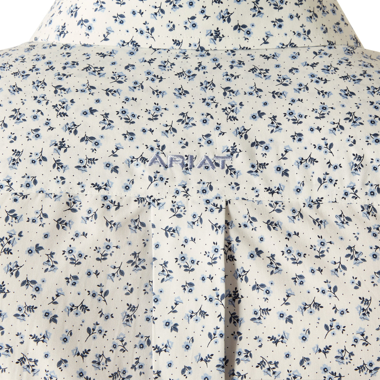 Man wearing a patterned shirt and jeans on a white background