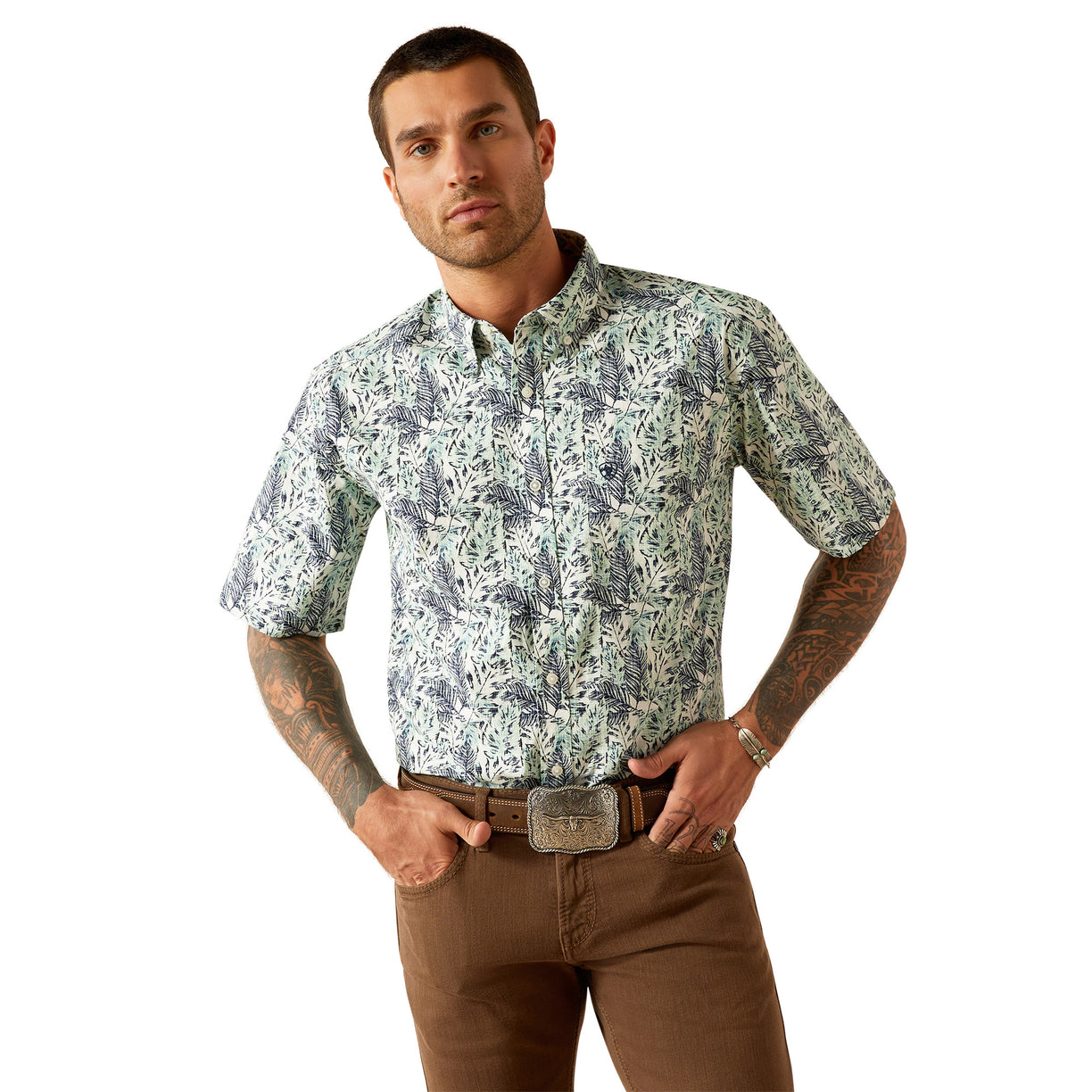 Man wearing a patterned shirt and brown pants on a white background