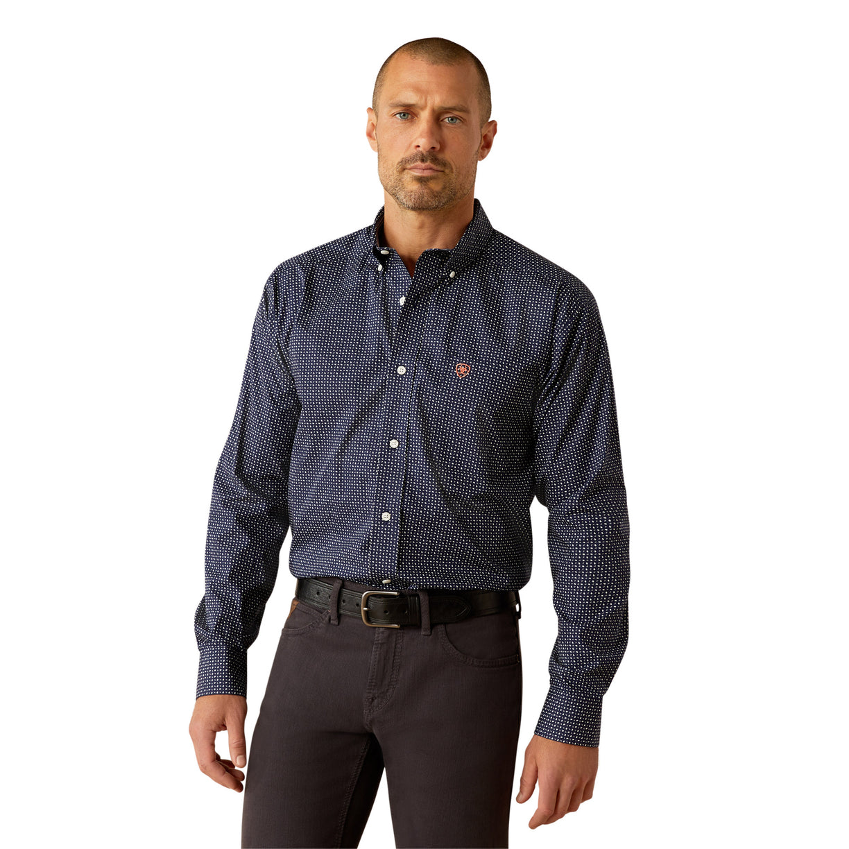 Man wearing a patterned dark shirt and dark pants on a white background