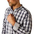 Man wearing a plaid shirt and jeans on a white background