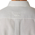 Man wearing a checkered shirt and jeans on a white background