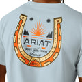 Light blue t-shirt with Ariat logo featuring a horseshoe and sun design on the back.
