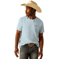 Person wearing a light blue t-shirt with a logo and a straw hat on a white background