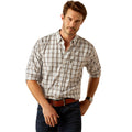 Man wearing a plaid shirt and dark pants on a white background