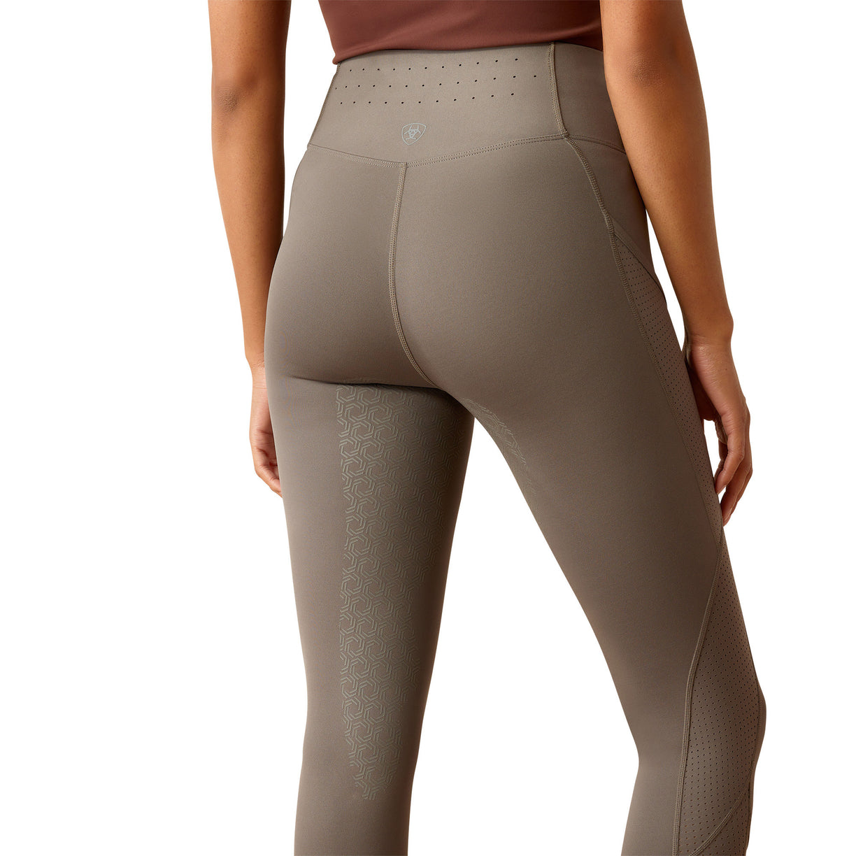 Brown leggings worn by a person on a white background