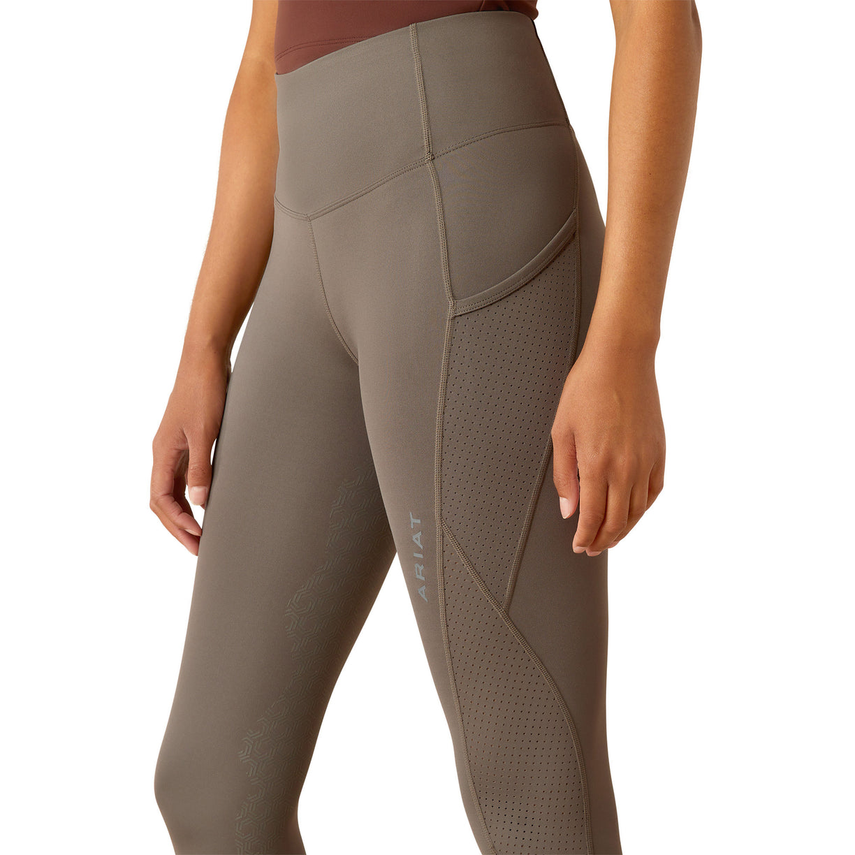 Brown leggings worn by a person on a white background