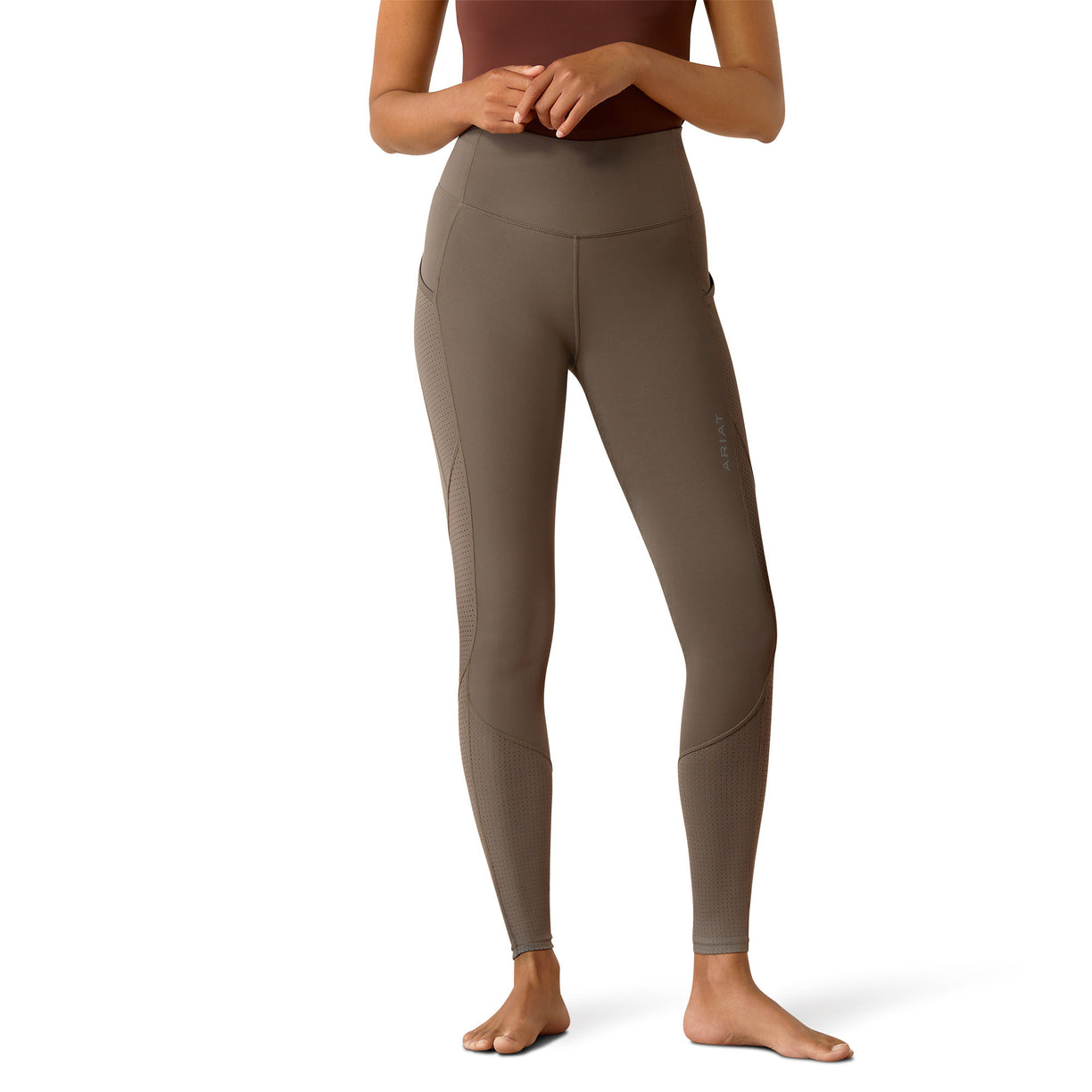 Brown leggings worn by a person on a white background