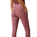 Pink leggings worn by a person on a white background