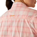 Person wearing a pink plaid shirt on a white background