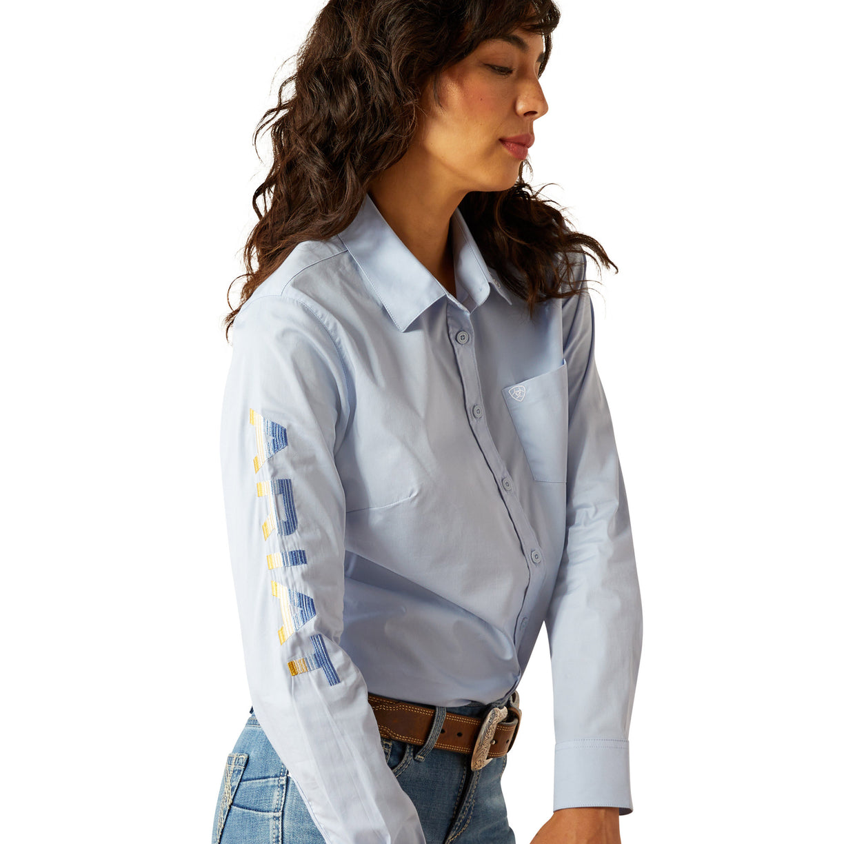 Woman wearing a light blue shirt and jeans on a white background