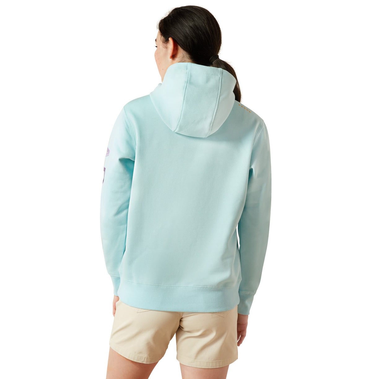 Person wearing a light blue hoodie with 'Ariat' branding on a white background