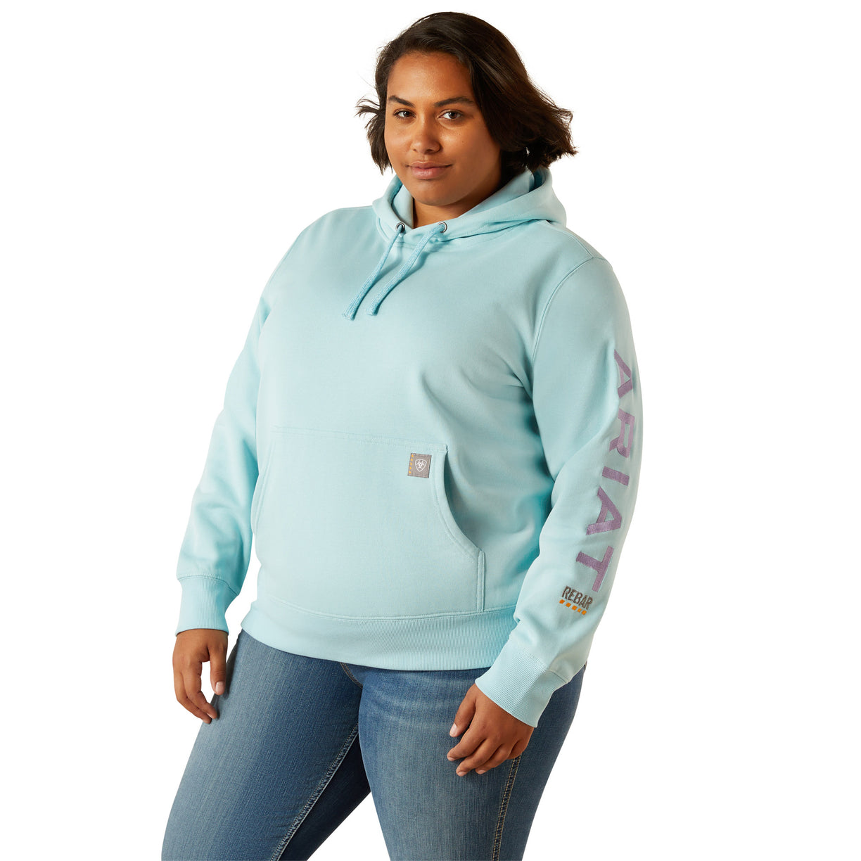 Person wearing a light blue hoodie with 'Ariat' branding on a white background