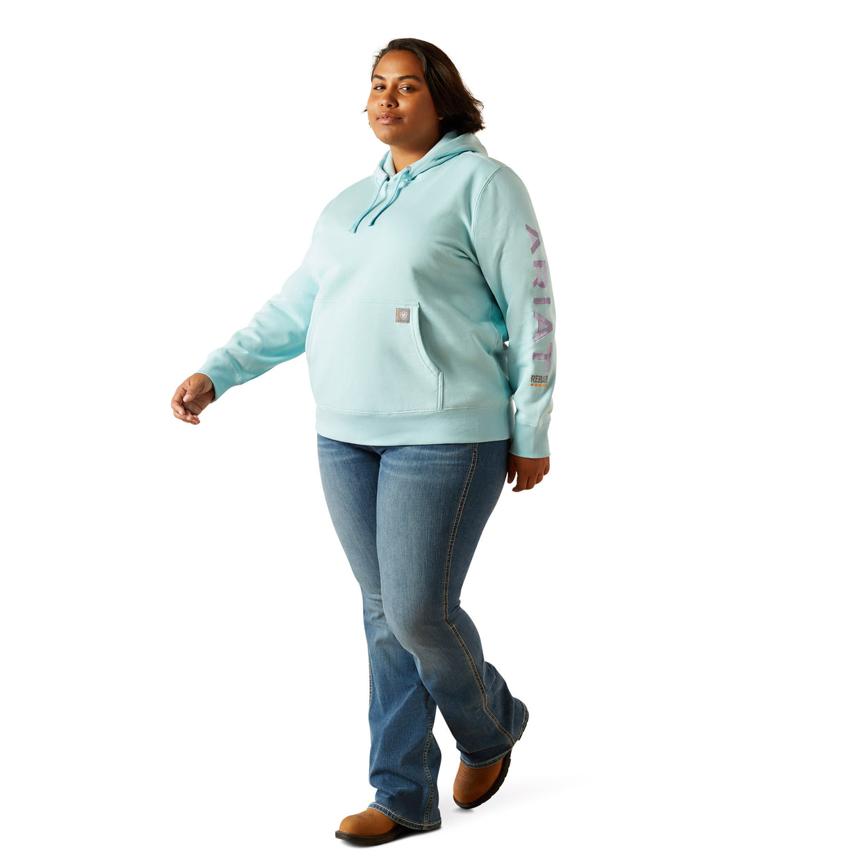 Person wearing a light blue hoodie with 'Ariat' branding on a white background