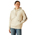Woman wearing a beige hoodie with Ariat brand logo on a white background