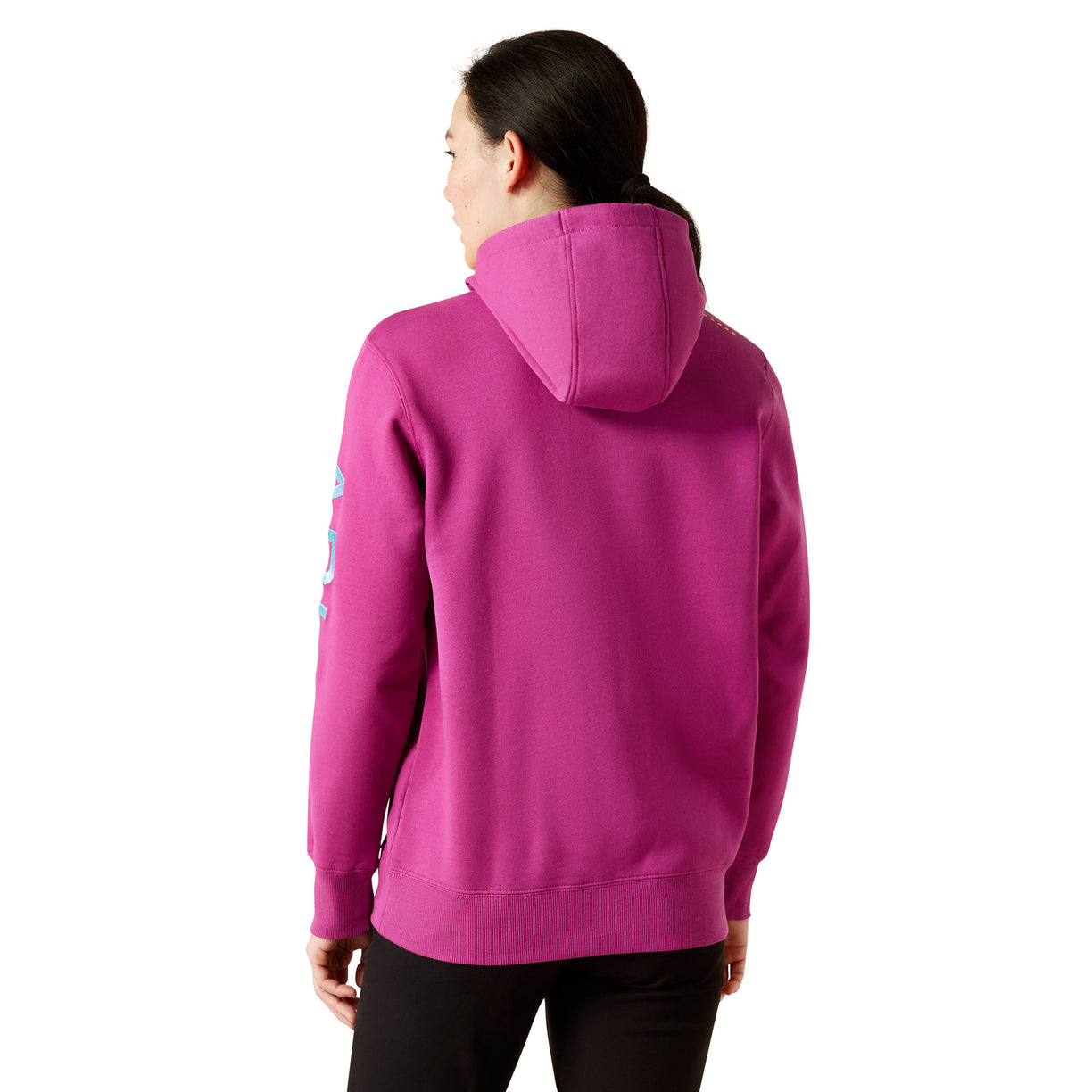 Person wearing a pink hoodie with Ariat brand logo on a white background