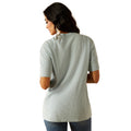 Woman wearing a gray t-shirt with a graphic design on a white background