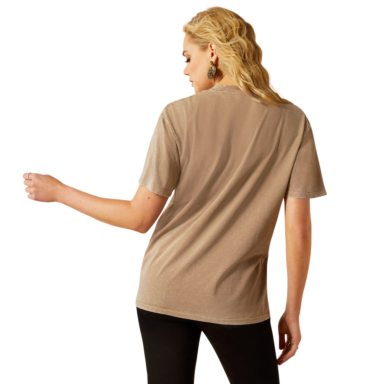 Woman wearing a beige t-shirt with a graphic design on a white background