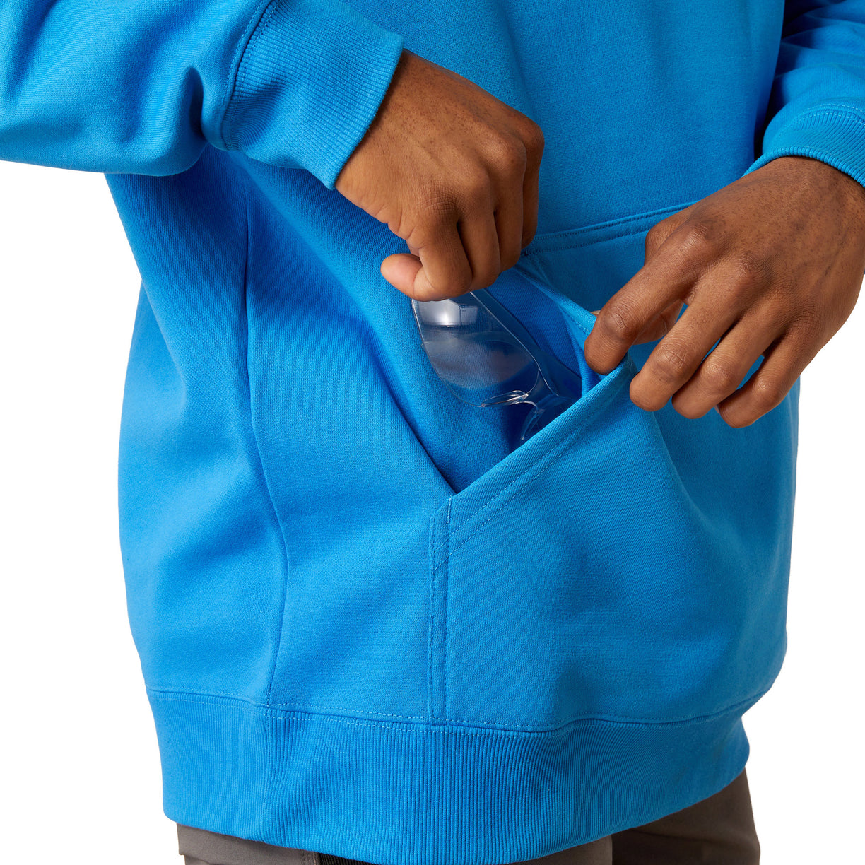 Man wearing a blue hoodie with Ariat brand logo on a white background