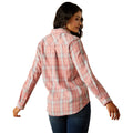 Woman wearing a pink plaid shirt, blue jeans, and a cowboy hat on a white background