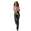 Woman wearing a pink plaid shirt, blue jeans, and a cowboy hat on a white background