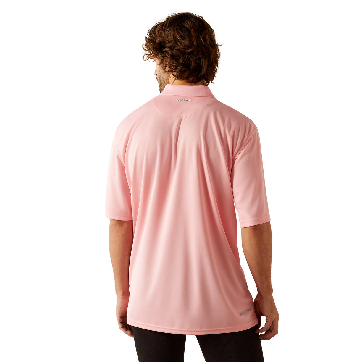 Man wearing a pink polo shirt with Ariat branding on a white background