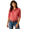 Woman wearing a red shirt and blue jeans on a white background