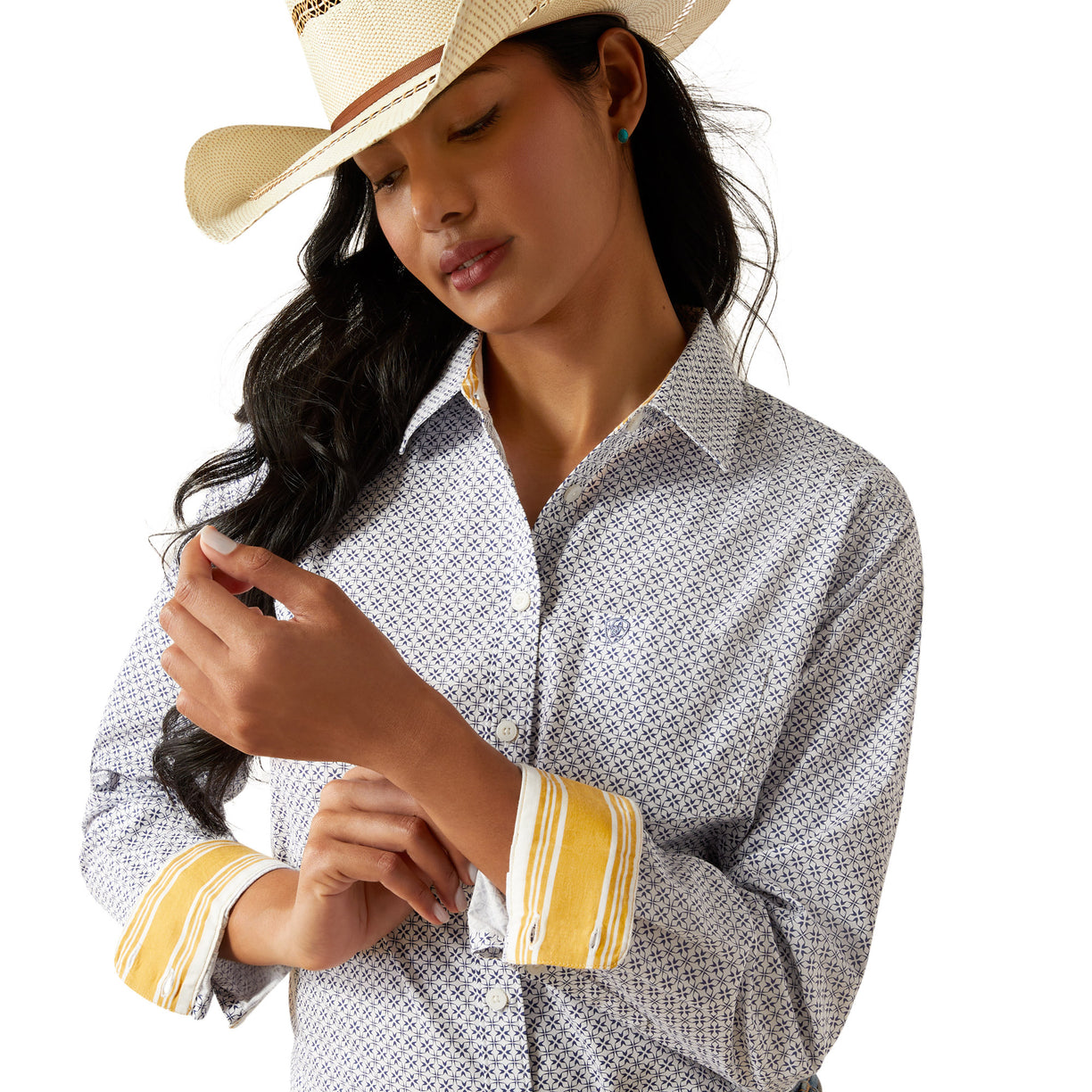 Woman wearing a patterned shirt, jeans, and a cowboy hat on a white background