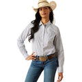 Woman wearing a patterned shirt, jeans, and a cowboy hat on a white background