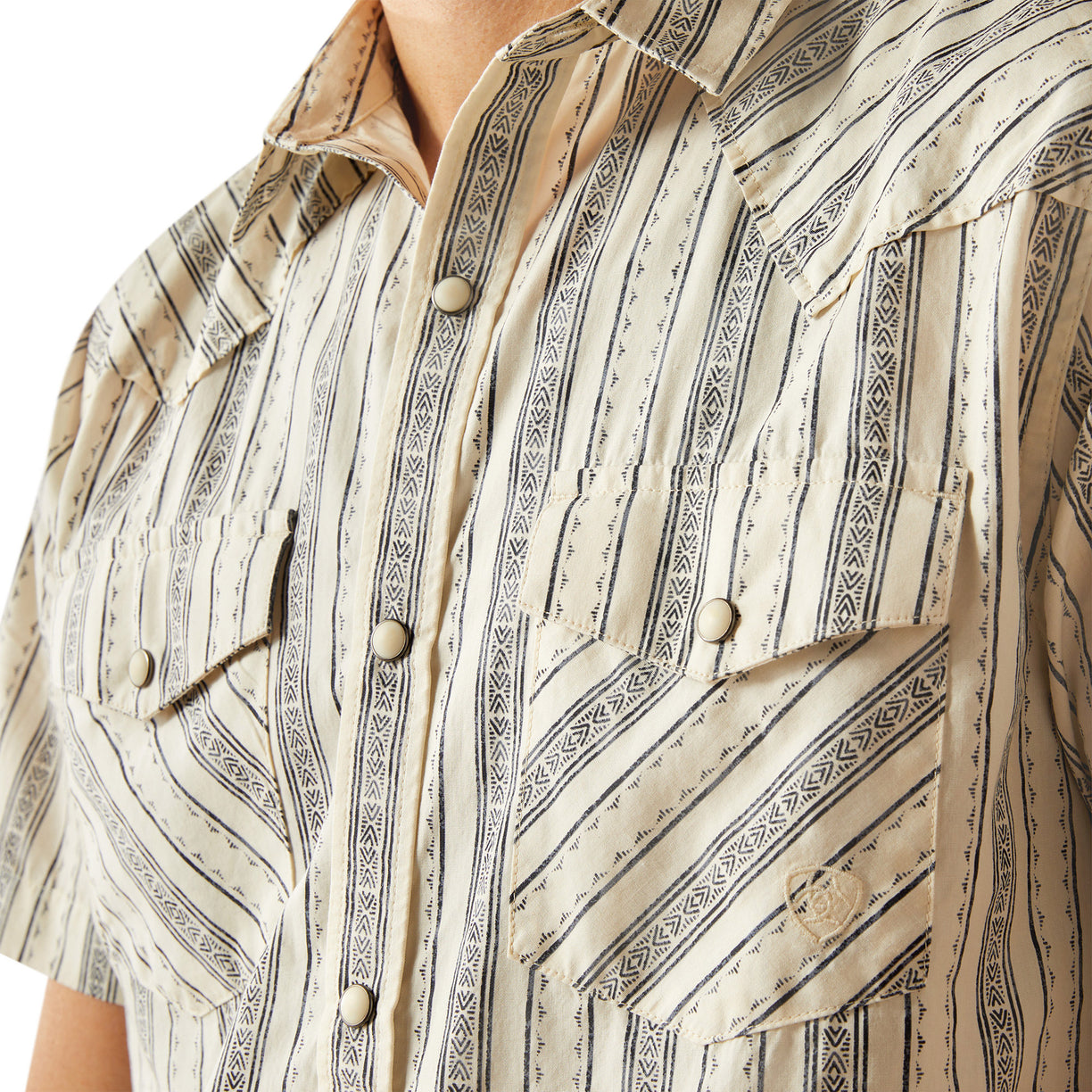 Close-up of a patterned shirt with vertical stripes and button details.