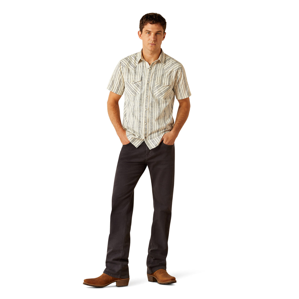 Man wearing a patterned shirt and dark pants on a white background