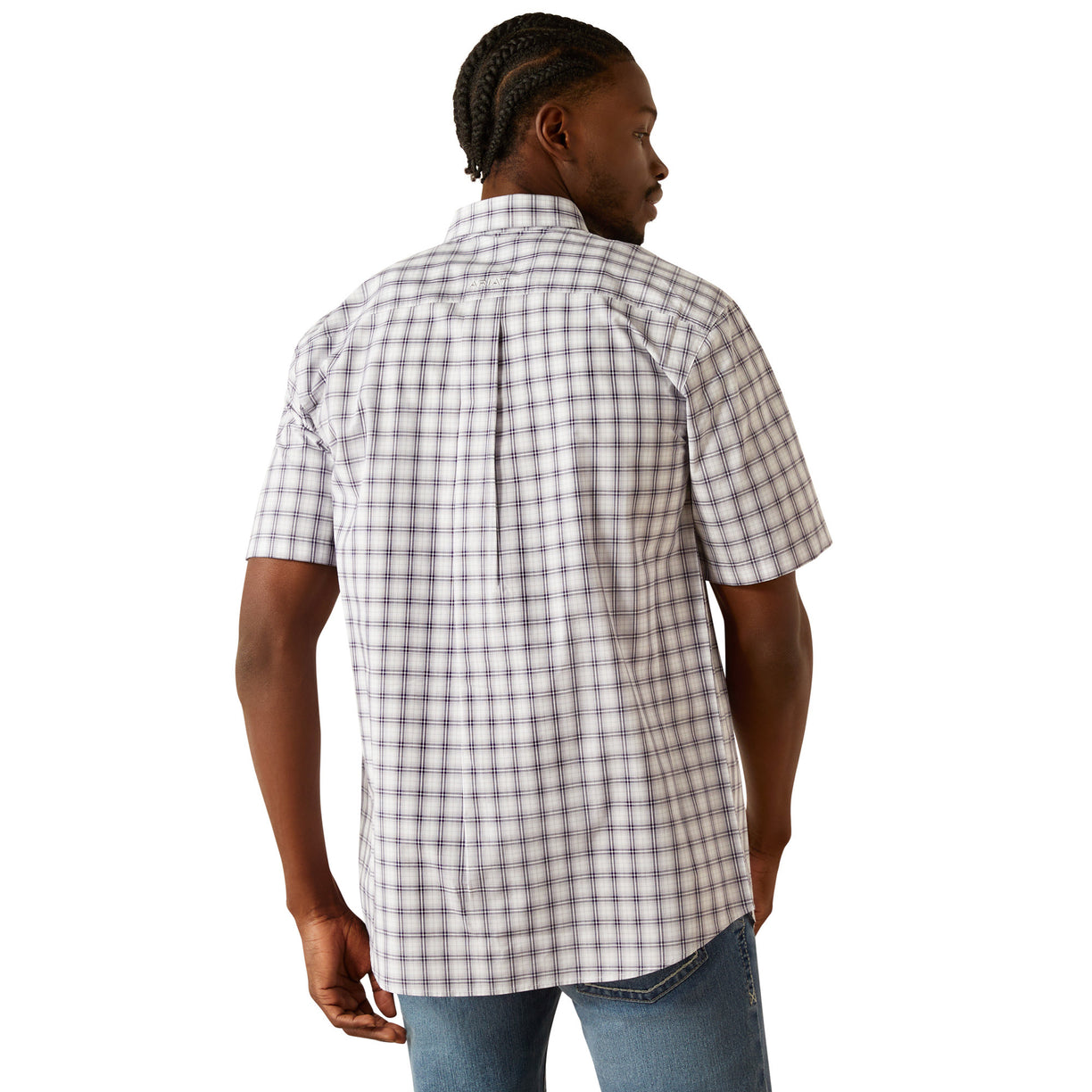 Man wearing a plaid shirt and jeans on a white background