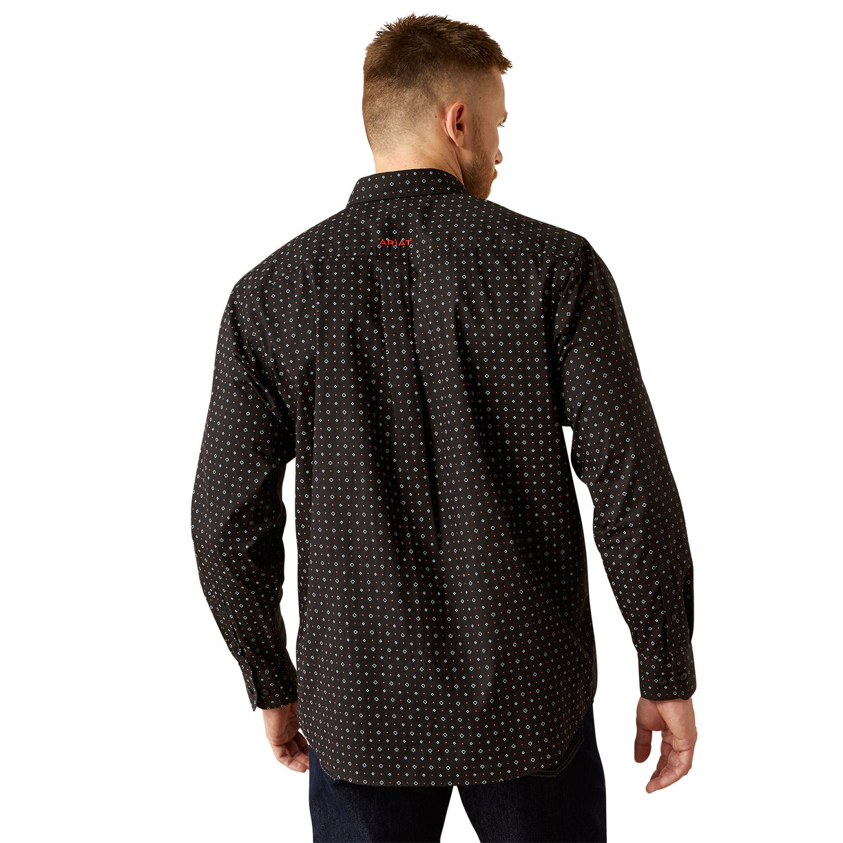 Man wearing a black patterned shirt on a white background